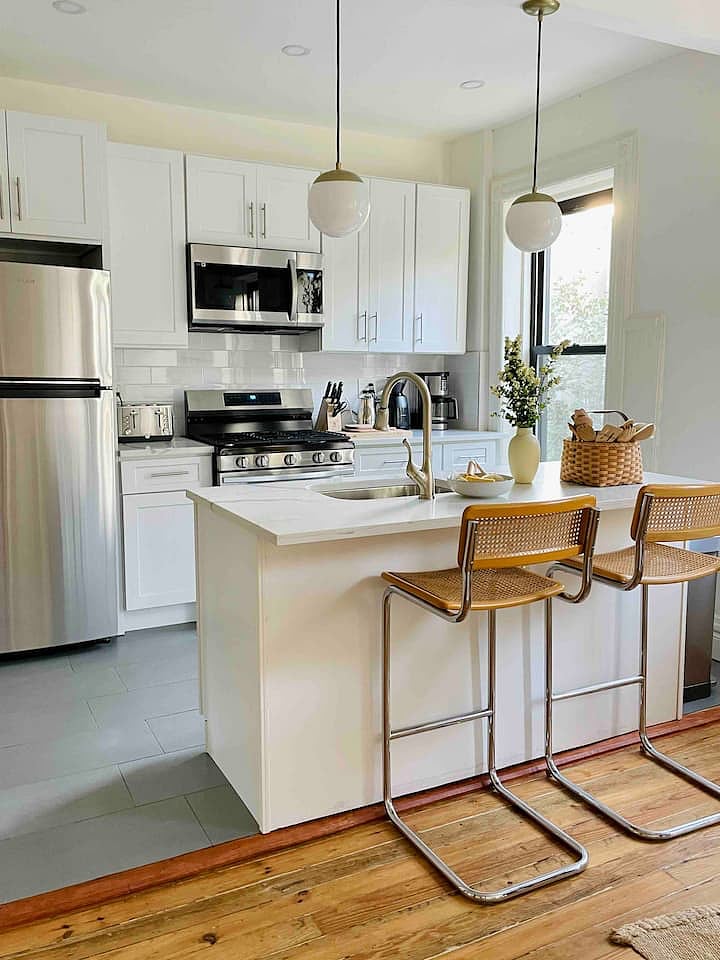 The kitchen is well stocked with a dishwasher, serving ware, pots, pans, multiple types of coffee makers, kitchen towels
