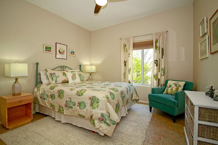 Queen bedroom with black out shades and cactus curtains
