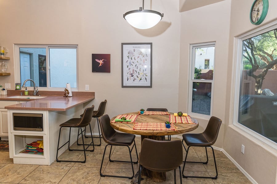 Kitchen eating nook with turquoise inlay table looks over back yard. Great place to start your day!