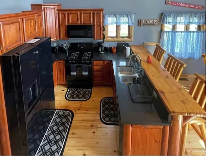 Fully equipped kitchen with bar seating and lake views.