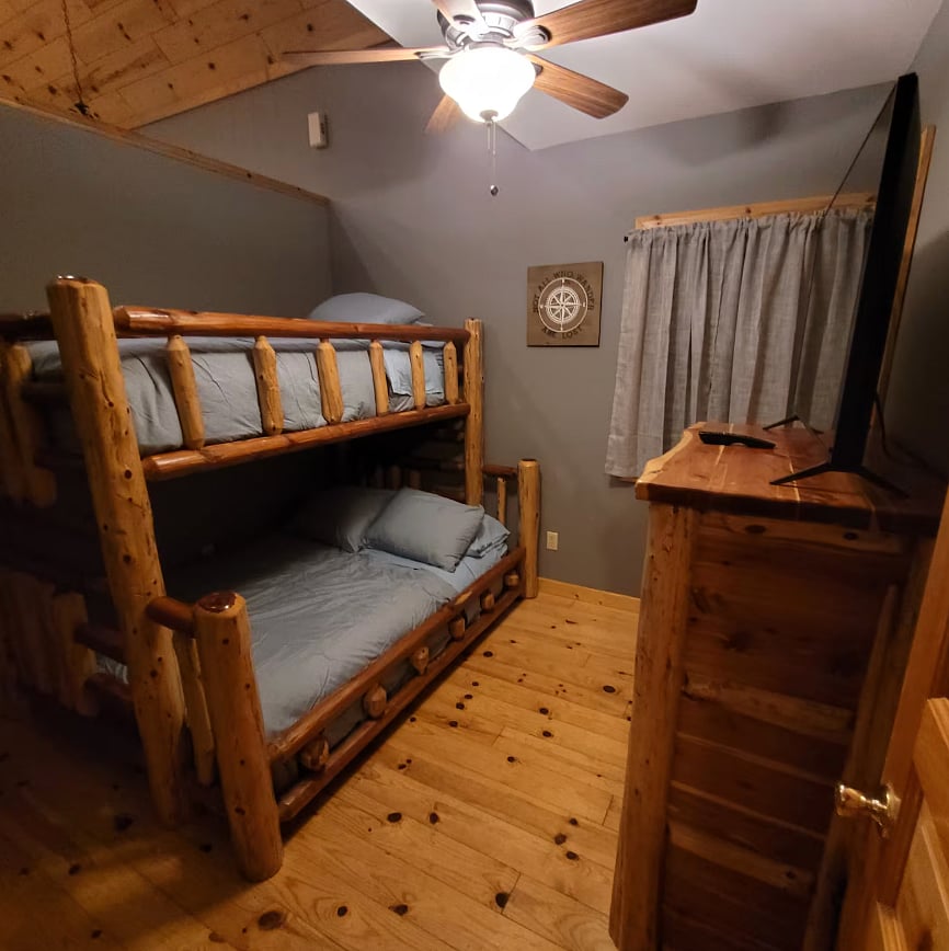 Guest bedroom with bunk beds and a smart TV.