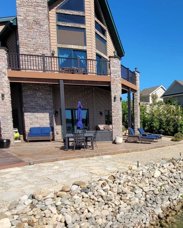 Waterfront exterior showing multiple outdoor living spaces.