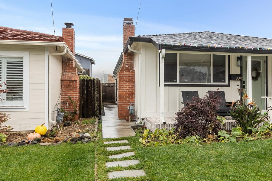 Exterior View of the home showing private walkway. Main entrance is on the right hand side at the end of the walkway.
