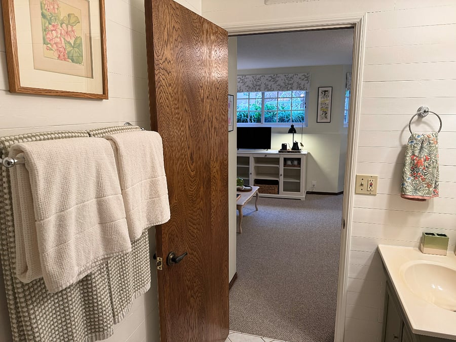 Luxe DKNY green-checked and plush Turkish cotton towels. That's a vintage watercolor of geraniums by V Cleveland, purchased at the famous Rose Bowl swap meet in the 1980s.