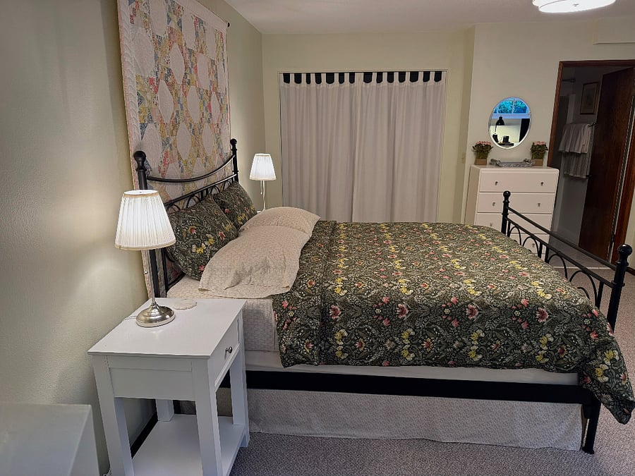 The 7'x8' closet is behind the white linen curtains.
