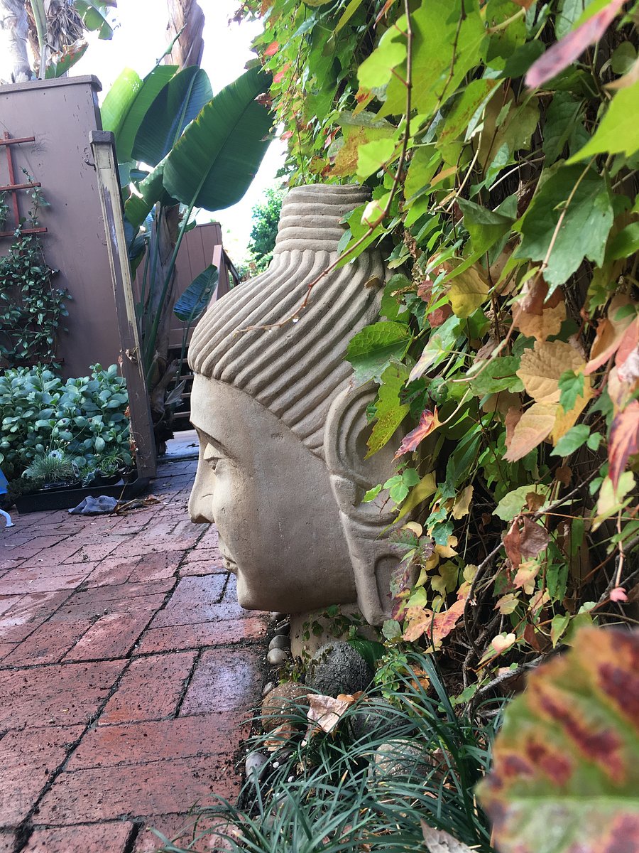 The Buddha is carved from an actual sandstone boulder. SO heavy.
