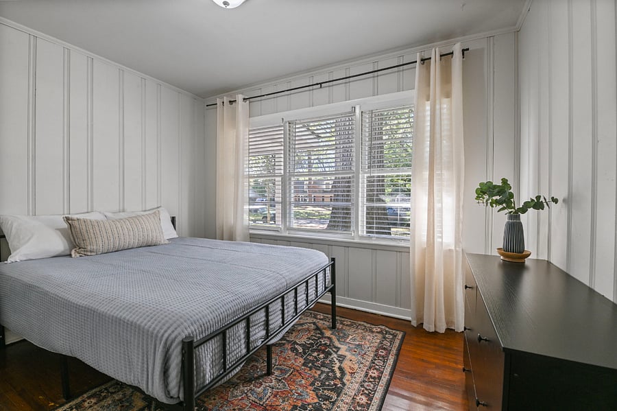 Comfortable second bedroom with a queen-sized bed and dedicated closet space.