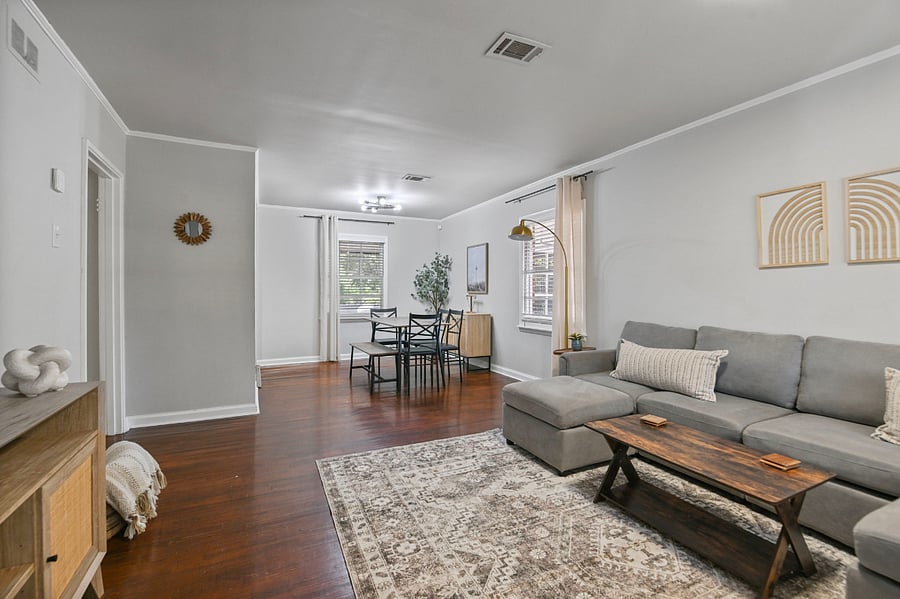 Open-concept layout connecting the living and dining areas, featuring beautiful hardwood floors throughout.