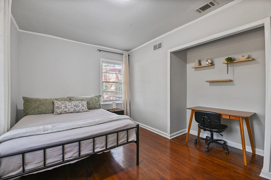 Versatile bedroom featuring a built-in desk, perfect for remote charting or study
