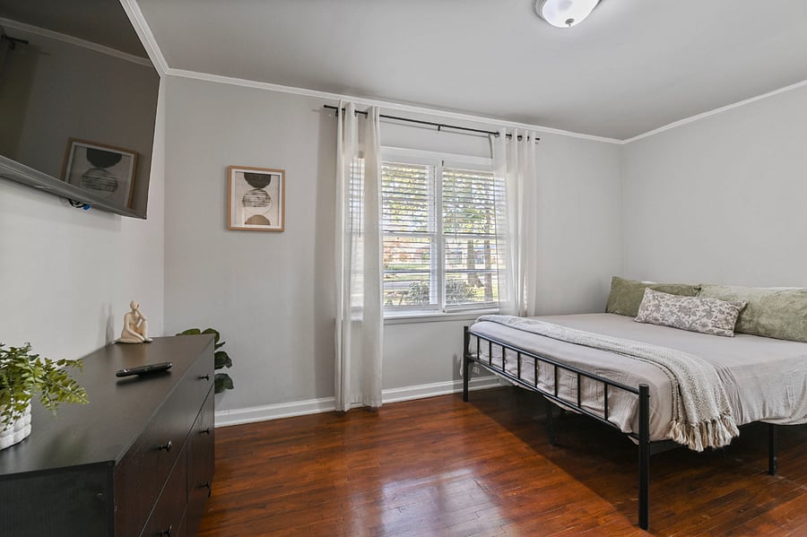 Serene primary suite featuring a brand-new 55-inch Vizio Smart TV and premium linens.