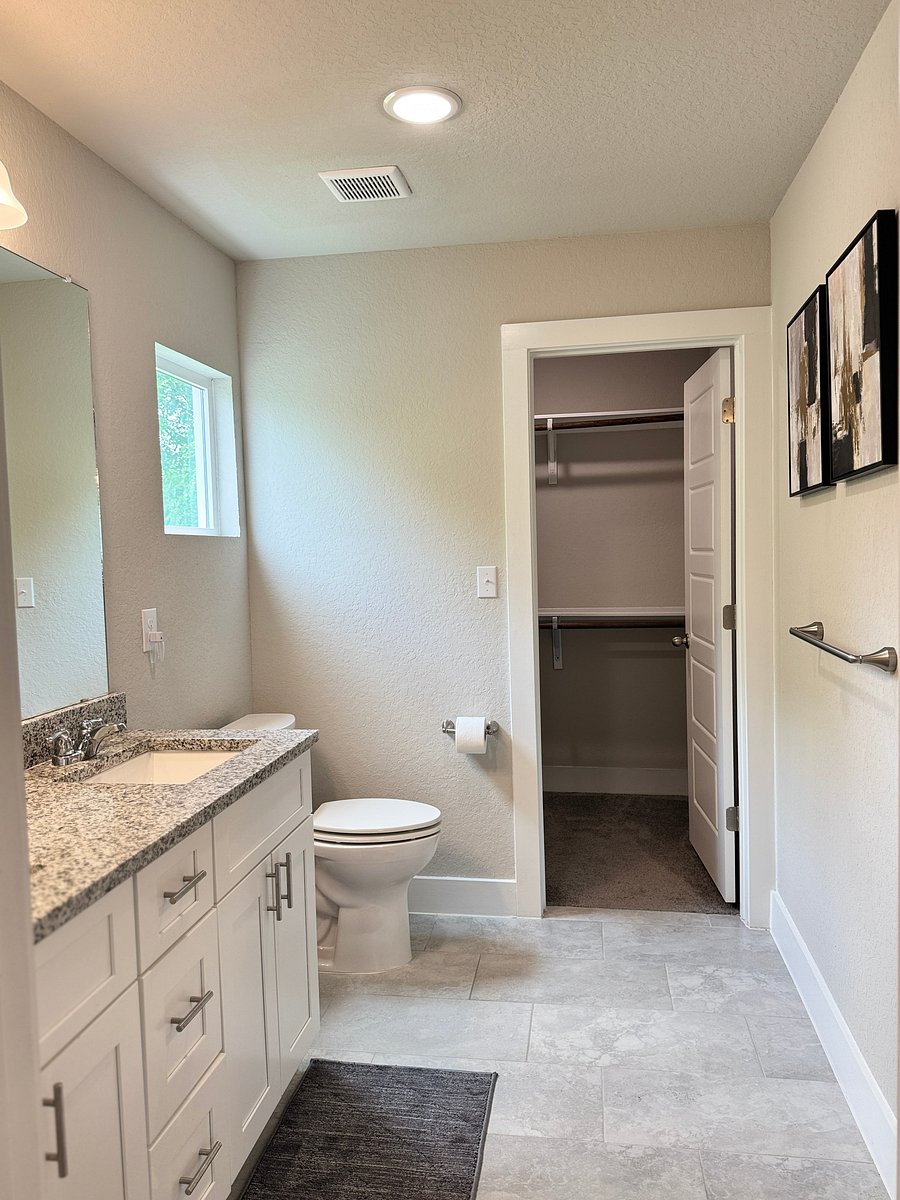 Master bath features a dual vanity and walk-in shower