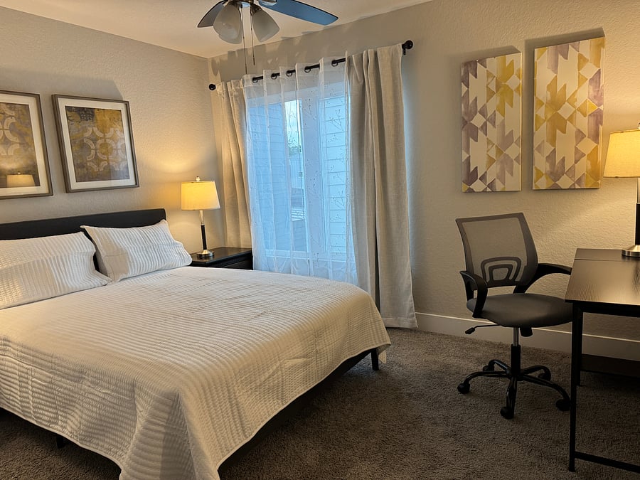 BEDROOM 3: features a queen bed, desk, chair and ensuite bathroom.