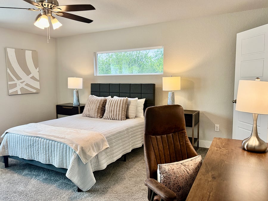 Master Bedroom: queen bed, desk/chair, dresser and ensuite bathroom featuring a walk-in shower and walk-in closet