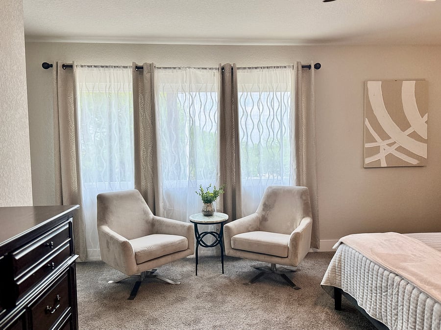 Master bedroom features a seating area to relax