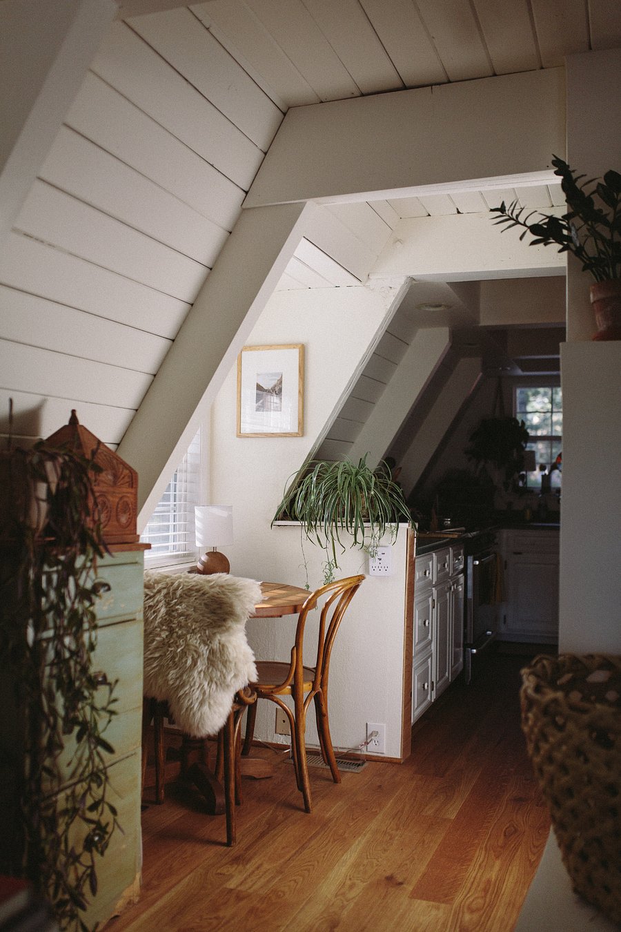 A sunny breakfast nook sits between the kitchen and living area