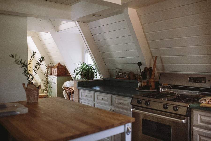 Kitchen features a gas range and butcher block island
