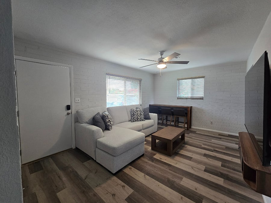 Open living area with L-shaped sectional and Smart TV