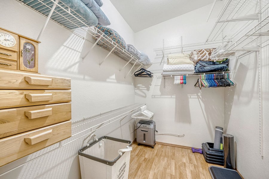 Primary Bedroom walk in closet with jewelry box and linens