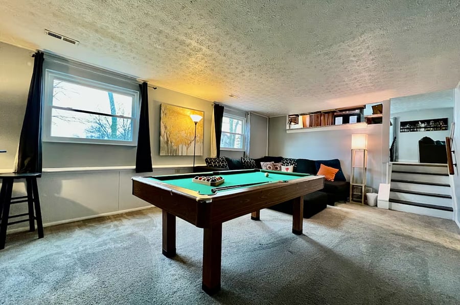 Secondary living room with seating and pool table