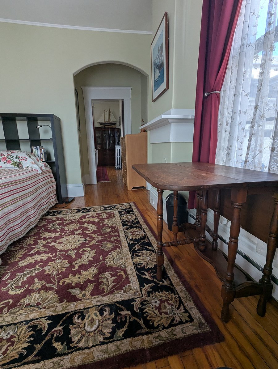 Bedroom, looking toward living room, with one of leaves of dropped-leaf table extended.