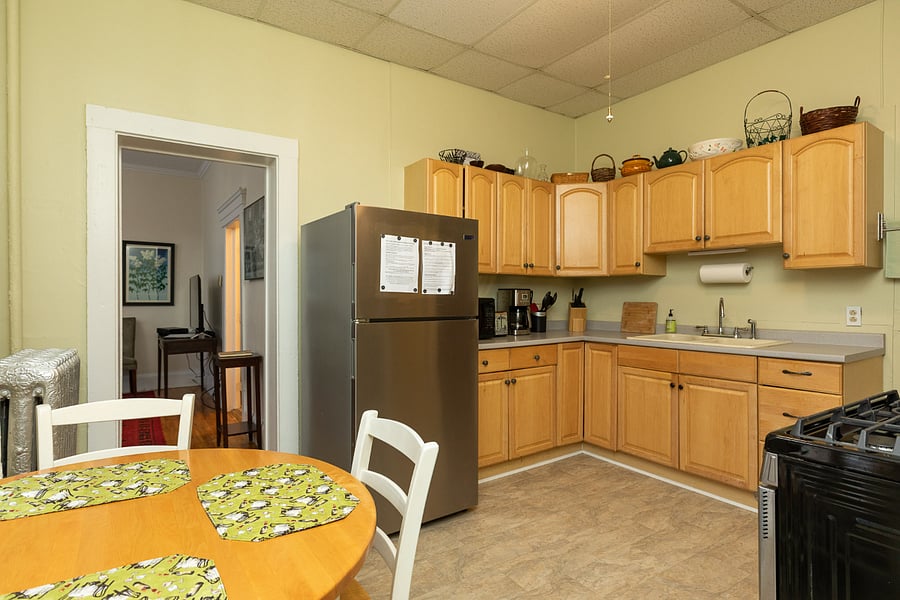 Eat-in kitchen, with full-sized refrigerator and stove, no dishwasher.