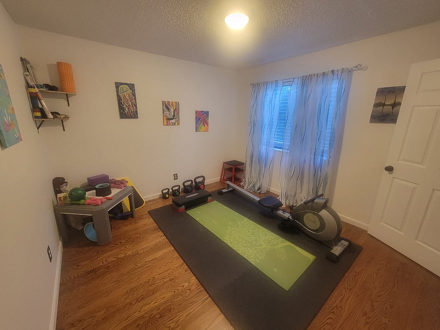 Shared workout room offering a row machine, yoga mats, small dumbells and kettle bells, jump boxes, and foam rollers.