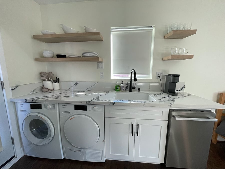 Brand new, low profile Miele appliances: washer, dryer, dishwasher. Large sink with garbage disposal.