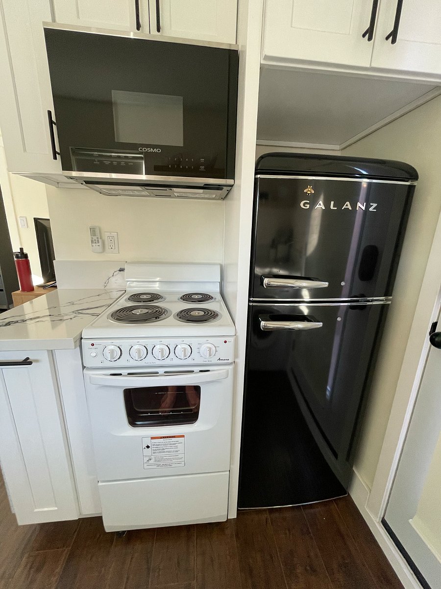 Full refrigerator and freezer, microwave, and range.