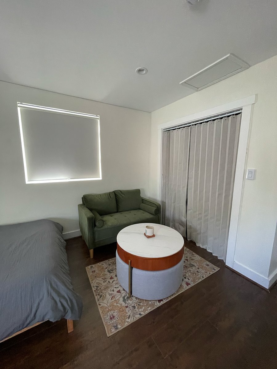 Living area w/ couch and coffee table/work area.
