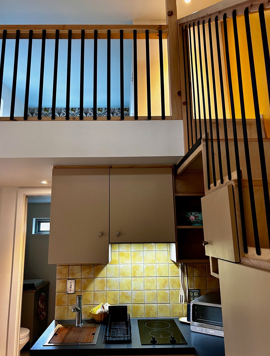 The kitchen and closets are cleverly tucked beneath the stairs and loft.