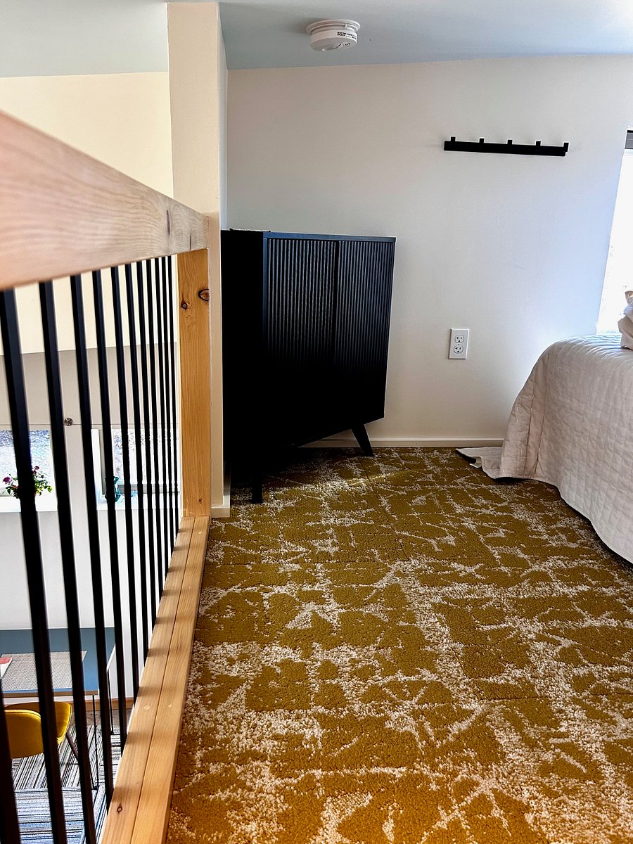 Golden wall to wall carpet in the sleeping loft makes this space warm and inviting.
