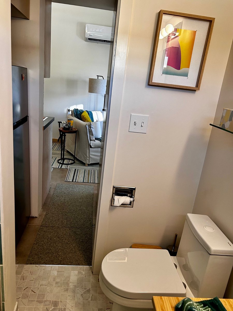 View from the bath to the tiny hall that houses the fridge, pantry, and coat closet.