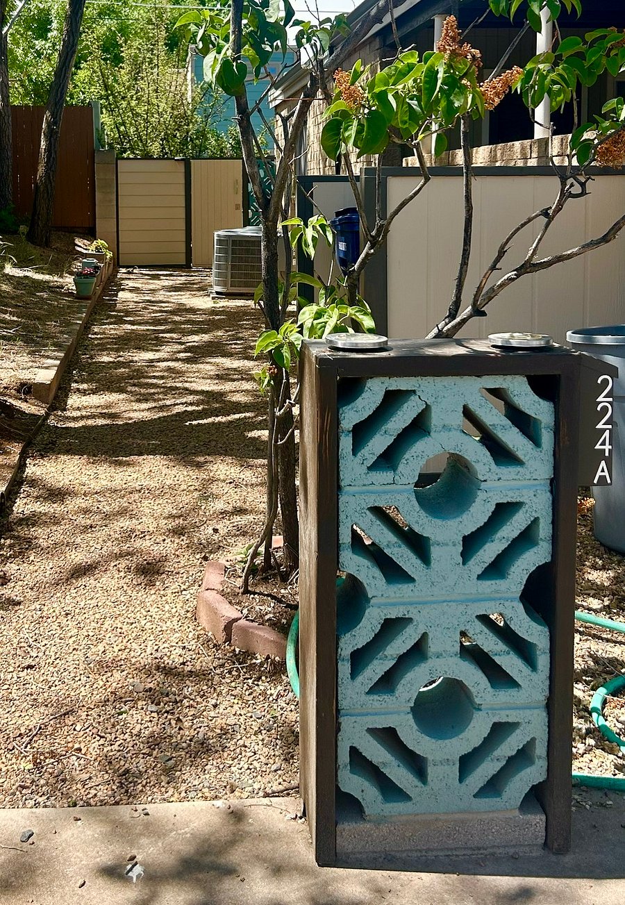 Mid-century breeze blocks mark your parking space and well lit walkway to the back yard and the Jewel Box.