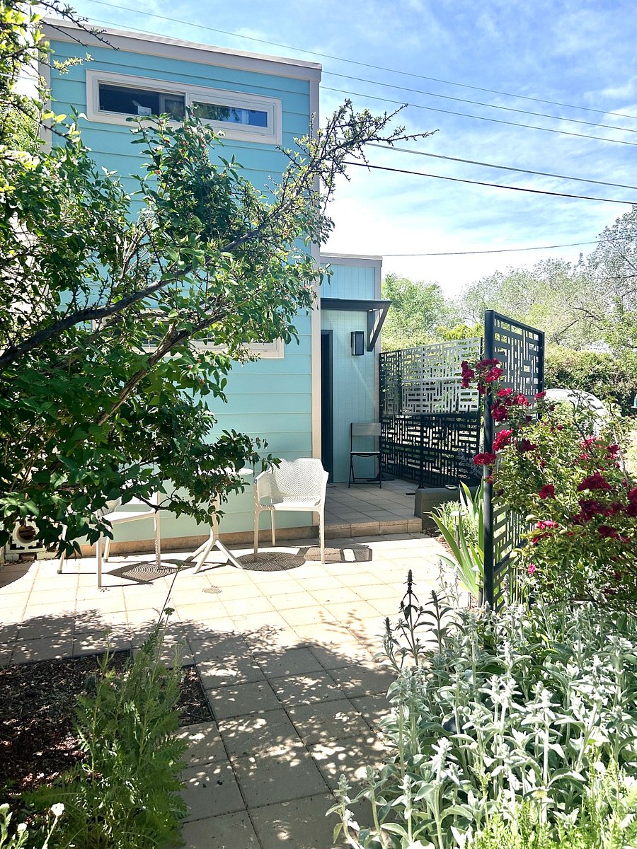 2 patios with verdant green landscaping make your tiny house more spacious and enjoyable