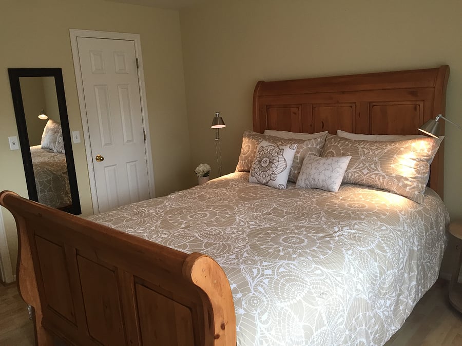 Spacious bedroom with comfortable bed, walk-in closet, and natural light