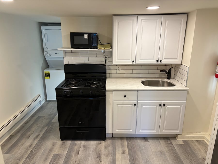 Kitchen with gas stoce, new cabinets, sink