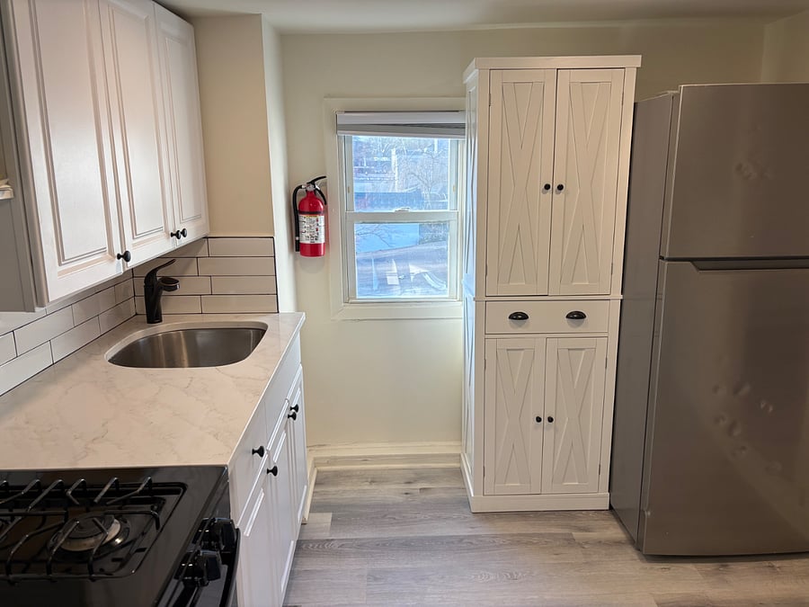 Kitchen view with window, pantry, and refrigerator