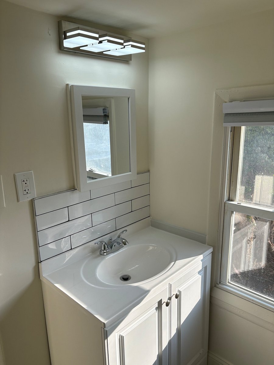 Bathroom vanity w/subway tiles and window