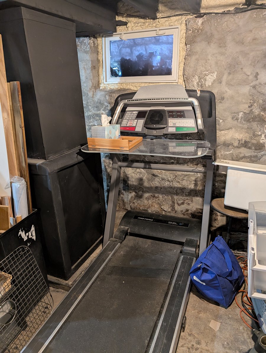 Treadmill with desk in basement. Free weights and stair climber also in basement.