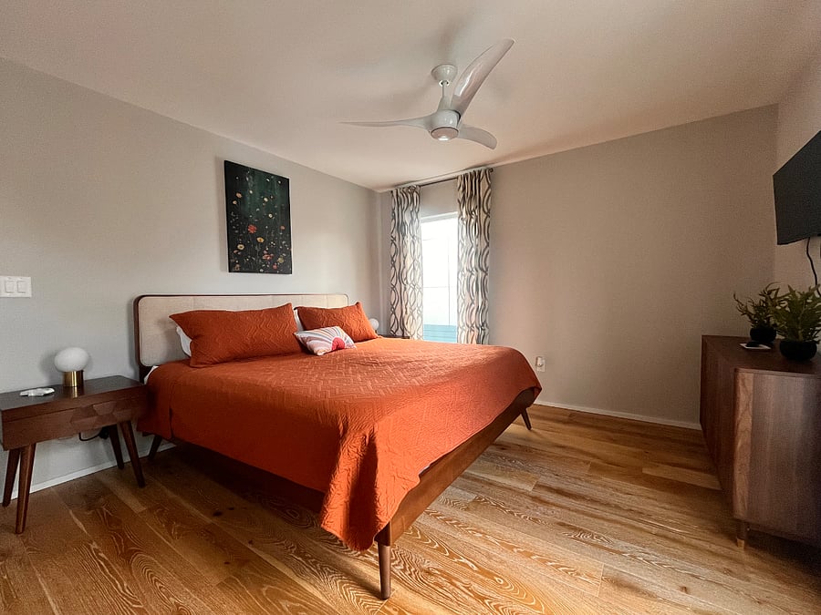 Cozy primary bedroom with king bed. Huge walk in closet and dresser for storage. Full length mirror for getting ready in the mornings.