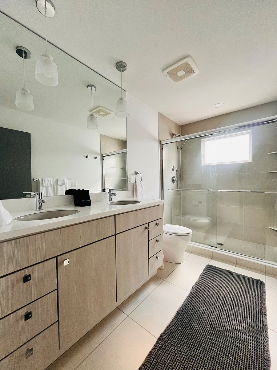 Primary bath with duel vanity and large walk in shower. Shower has 2 shower heads.