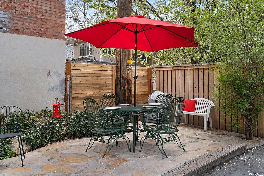 Relax and unwind in the shared patio featuring a dining area and cozy firepit, perfect for meals, gatherings, or enjoying a quiet evening outdoors.
