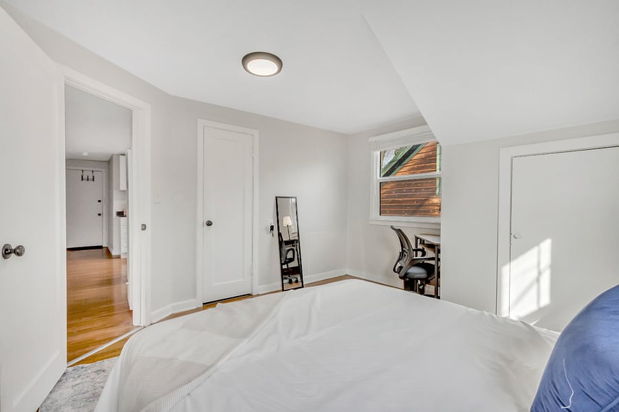 Dedicated desk and office chair, two large closets and a queen bed make this a very functional living space.
