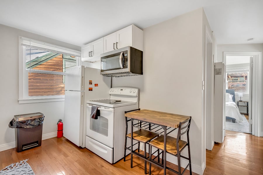 Full sized refrigerator/freezer, microwave, and oven. Small dining table and two chairs.