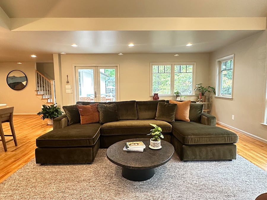 The Great Room, vaulted ceilings & expansive windows offer views over an acre of forest & a creek tributary. Natural light fills the space.