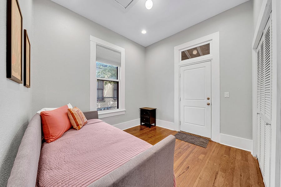 The back bedroom has a twin daybed and a door to the screened in back porch.
