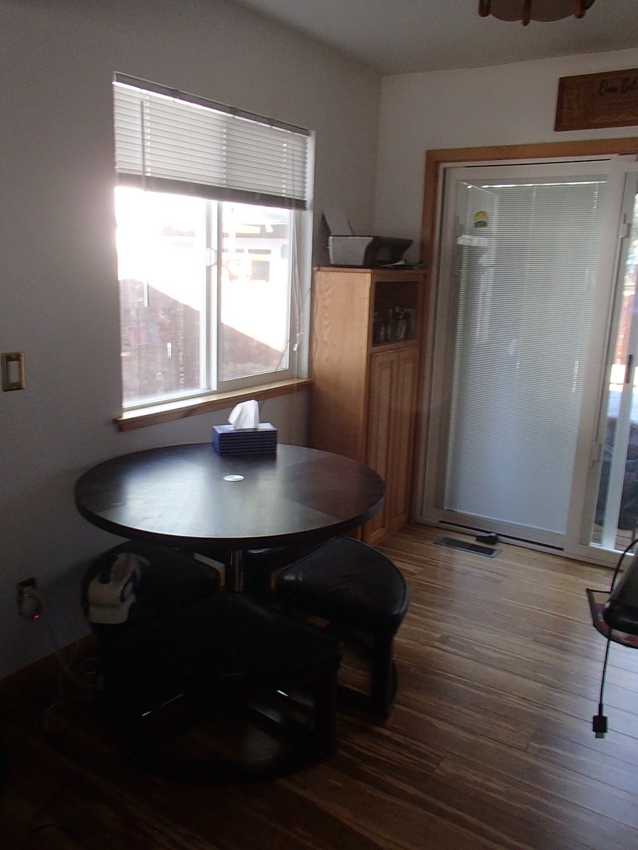 Small dining area with a pub table. Additional dining options at kitchen counter.