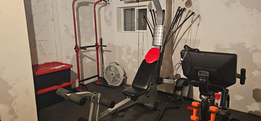 Downstairs exercise area - BowFlex and pullup bar (boxes on left are personal belongings)