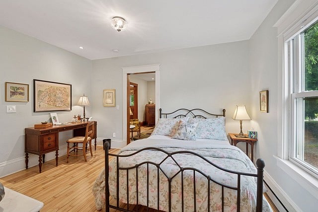 Full size bed and writers desk and bathroom nearby on first floor.