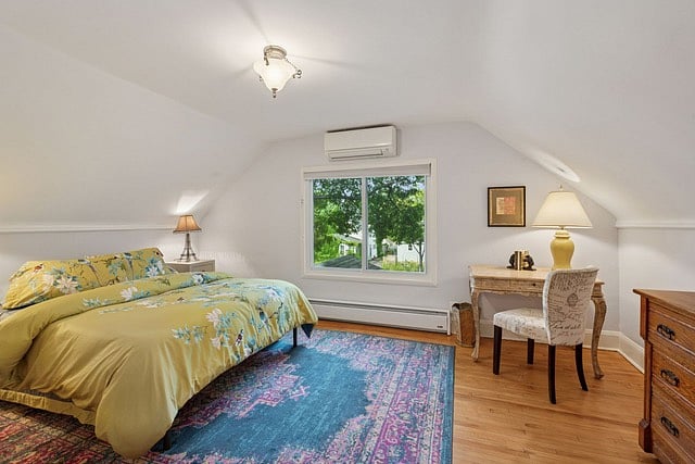 Upstairs bedroom with stunning view of a large oak tree and writers desk.
